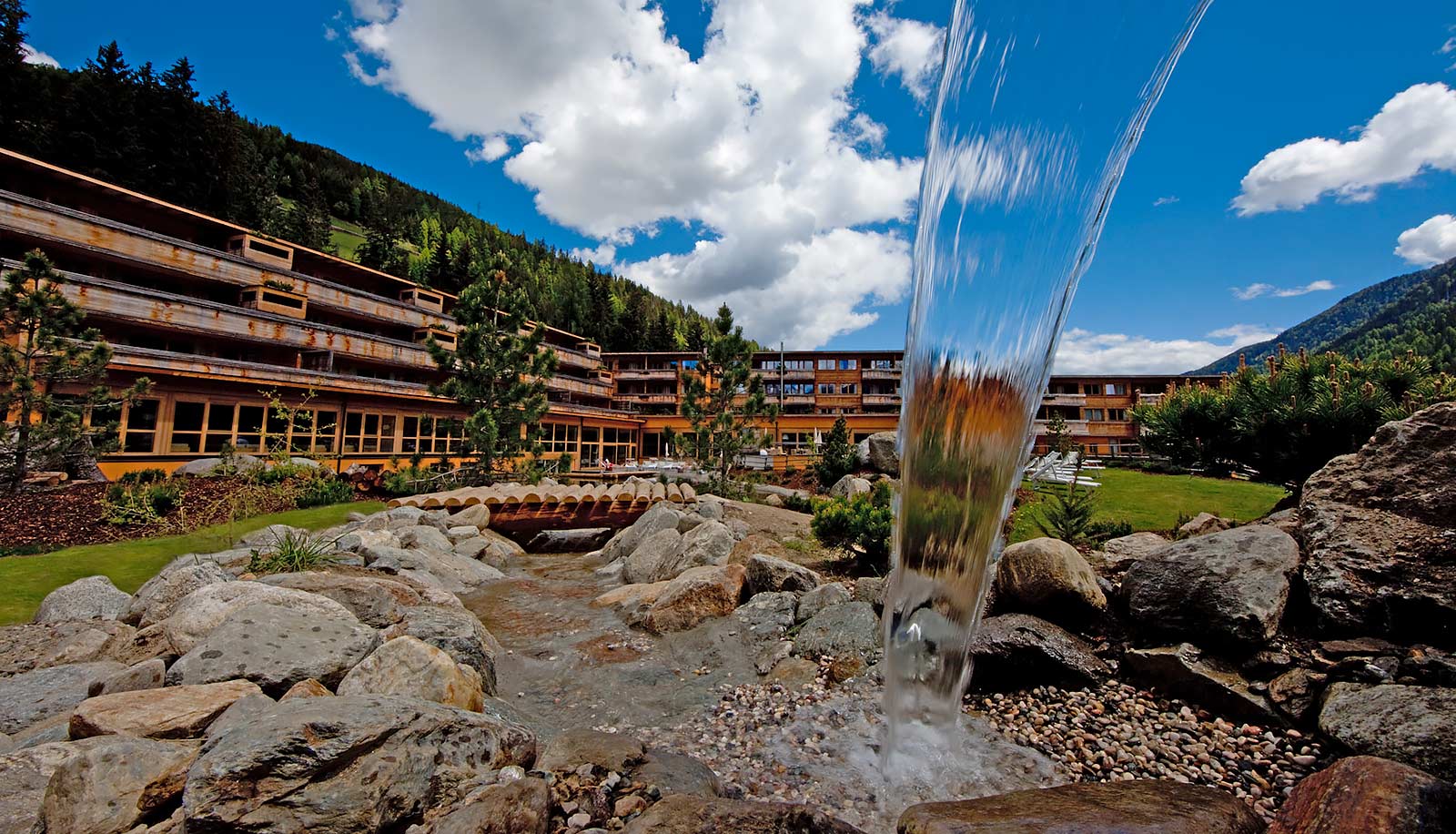Exterior view of Arosea Hotel in Ultental-Val d'Ultimo as seen from a fountain